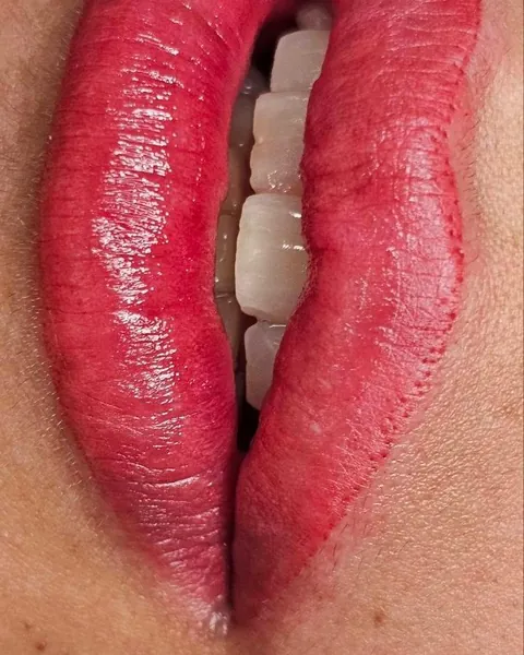 Close-up of PMU lips in a bright rosy red
