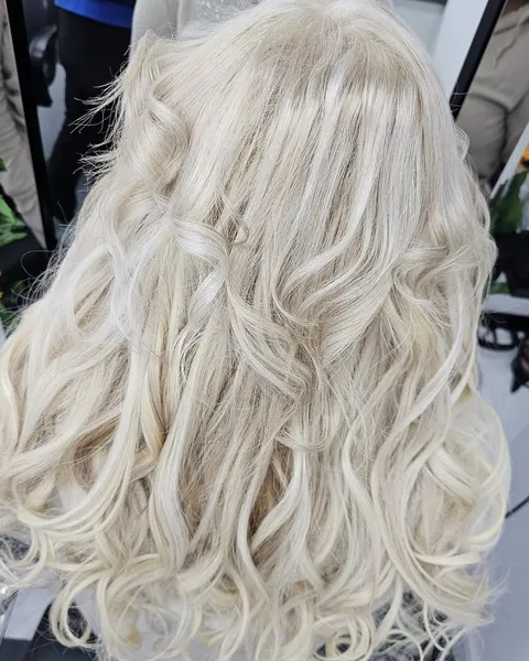 Bright platinum blonde hair styled in soft waves