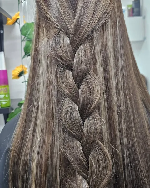 Long brown hair with soft highlights in a loose plait